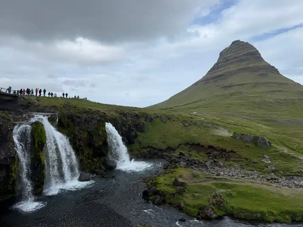 Black church with Icelandic flag and stone foundation