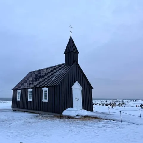 Black wooden church at Búðir in the snow