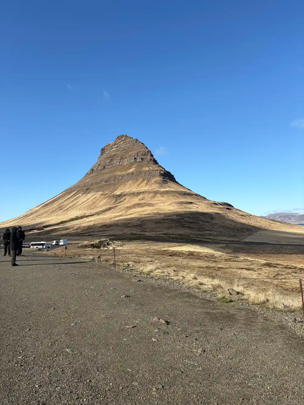 Cone-shaped mountain with dark volcanic stripes and slopes