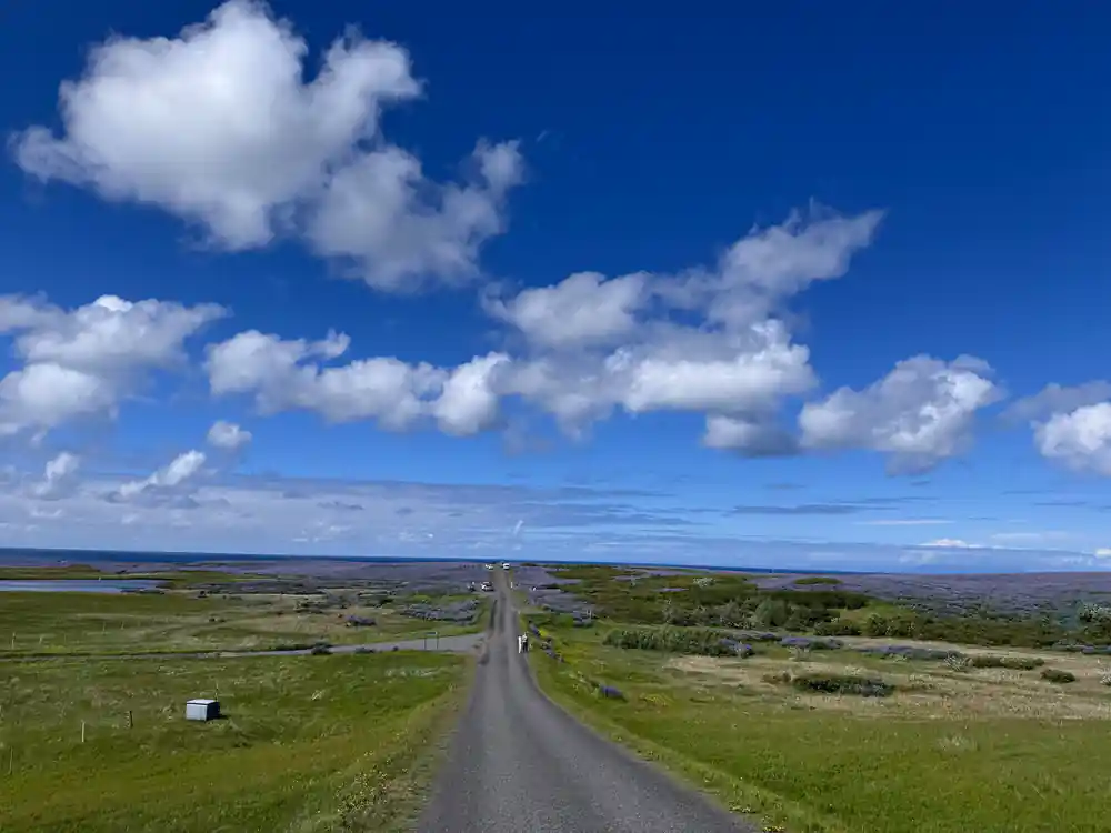 Straight road stretching across flat green landscape