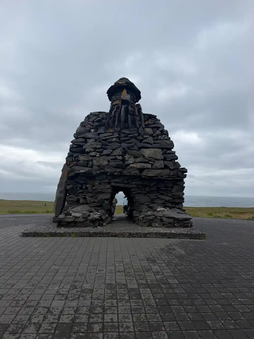 Tall stacked stone monument on paved platform